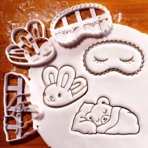 Fluffy bunny slipper, eye mask with closed eye and sleeping bear cookie cutter